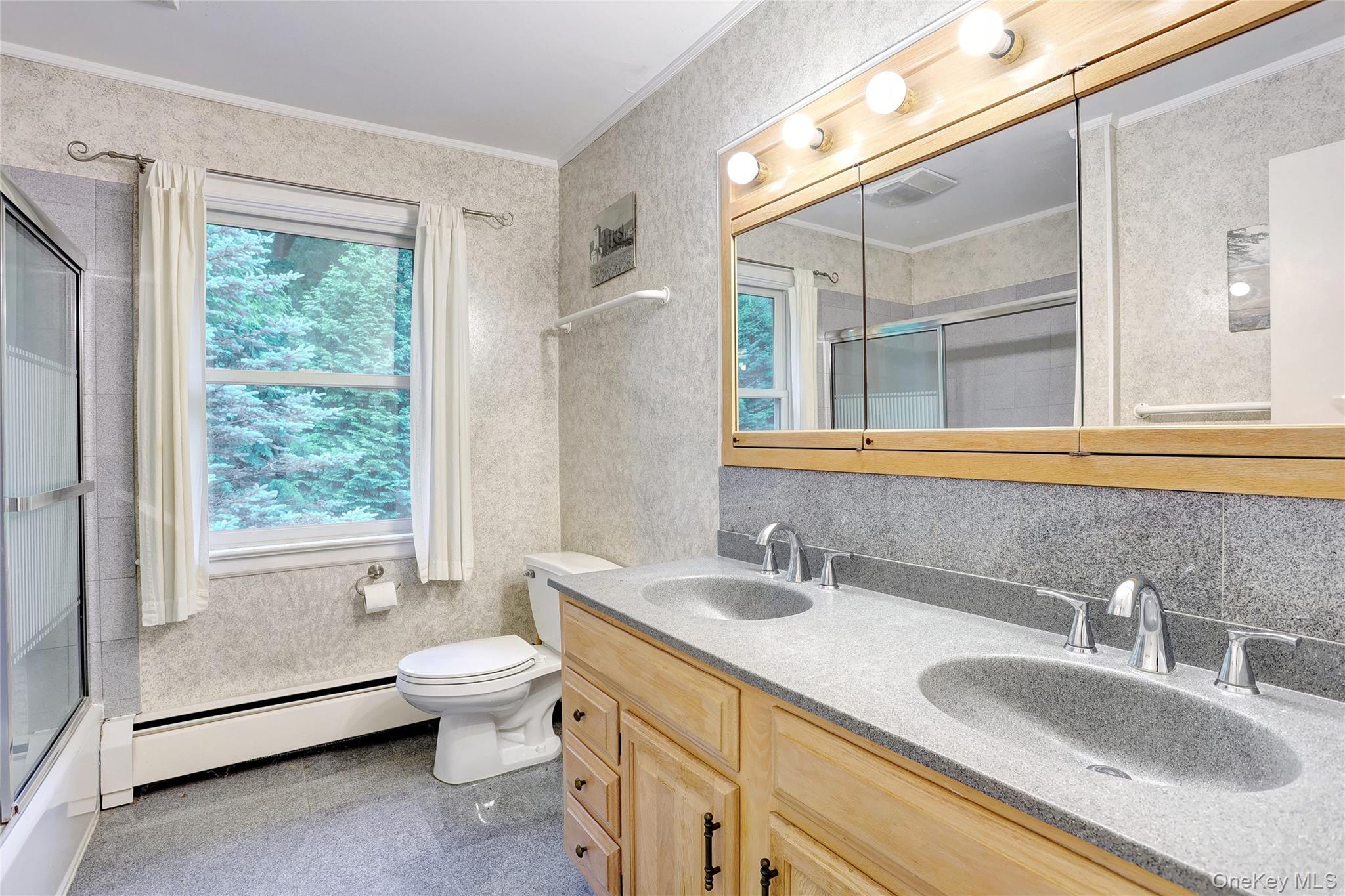 8 Swallow Avenue Spring Valley, NY 10977 - Photo 18 of 28 a bathroom with a granite countertop sink and a large mirror
