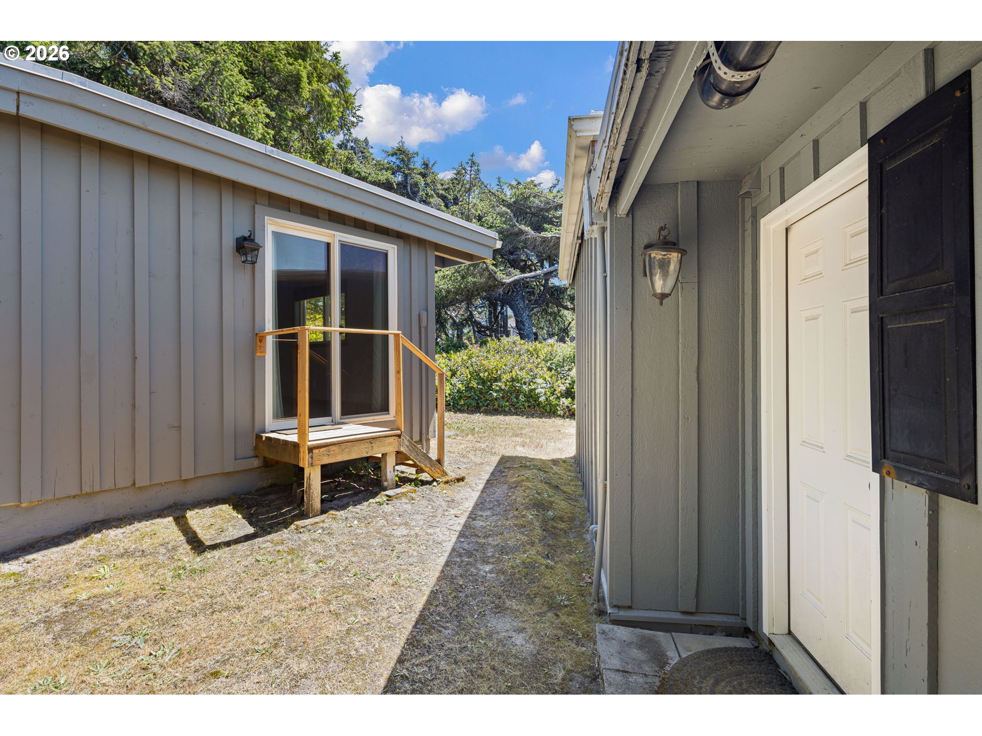 88481 1st Avenue Florence, OR 97439 - Photo 20 of 43 a backyard of a house with wooden floor and outdoor seating