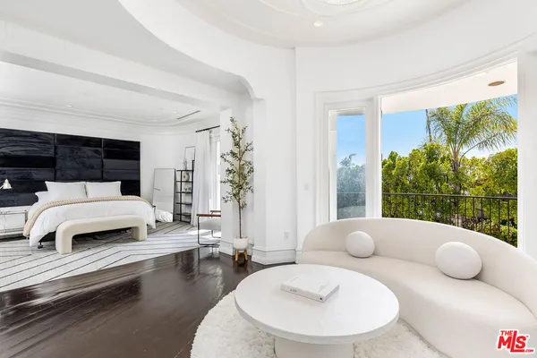 a bedroom with furniture and a potted plant