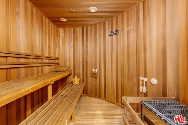 a view of a house with a yard potted plants and large tree