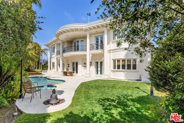a front view of a house with swimming pool patio and fire pit