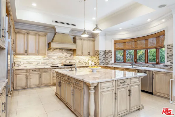 a kitchen with granite countertop a sink stove and cabinets
