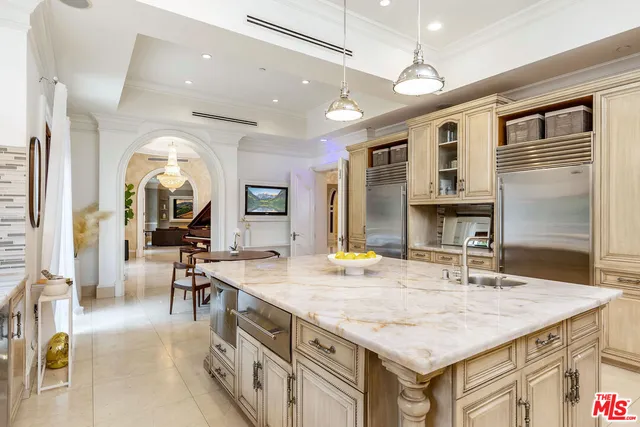 a bathroom with a sink a vanity and a large mirror