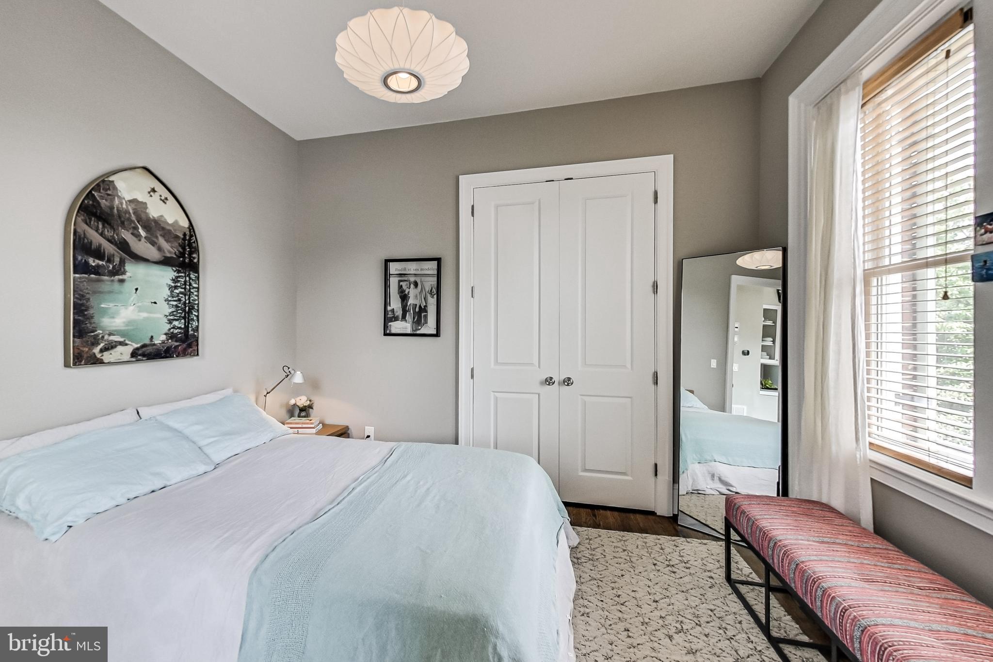 3324 18th Street Northwest, Unit 9 Washington, DC 20010 - Photo 25 of 44 a bedroom with a bed and a chandelier