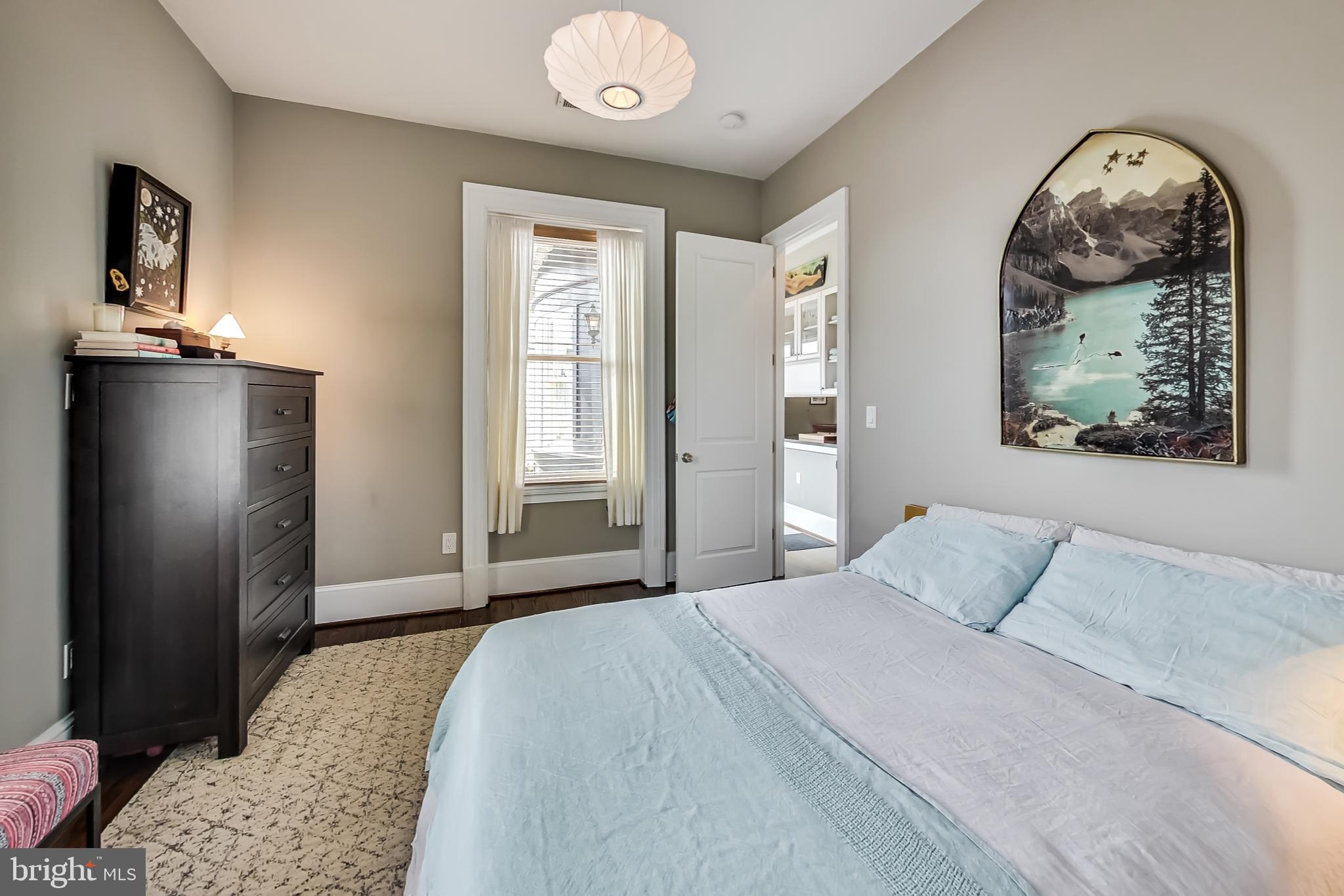 3324 18th Street Northwest, Unit 9 Washington, DC 20010 - Photo 26 of 44 a bedroom with a bed and a painting on the wall