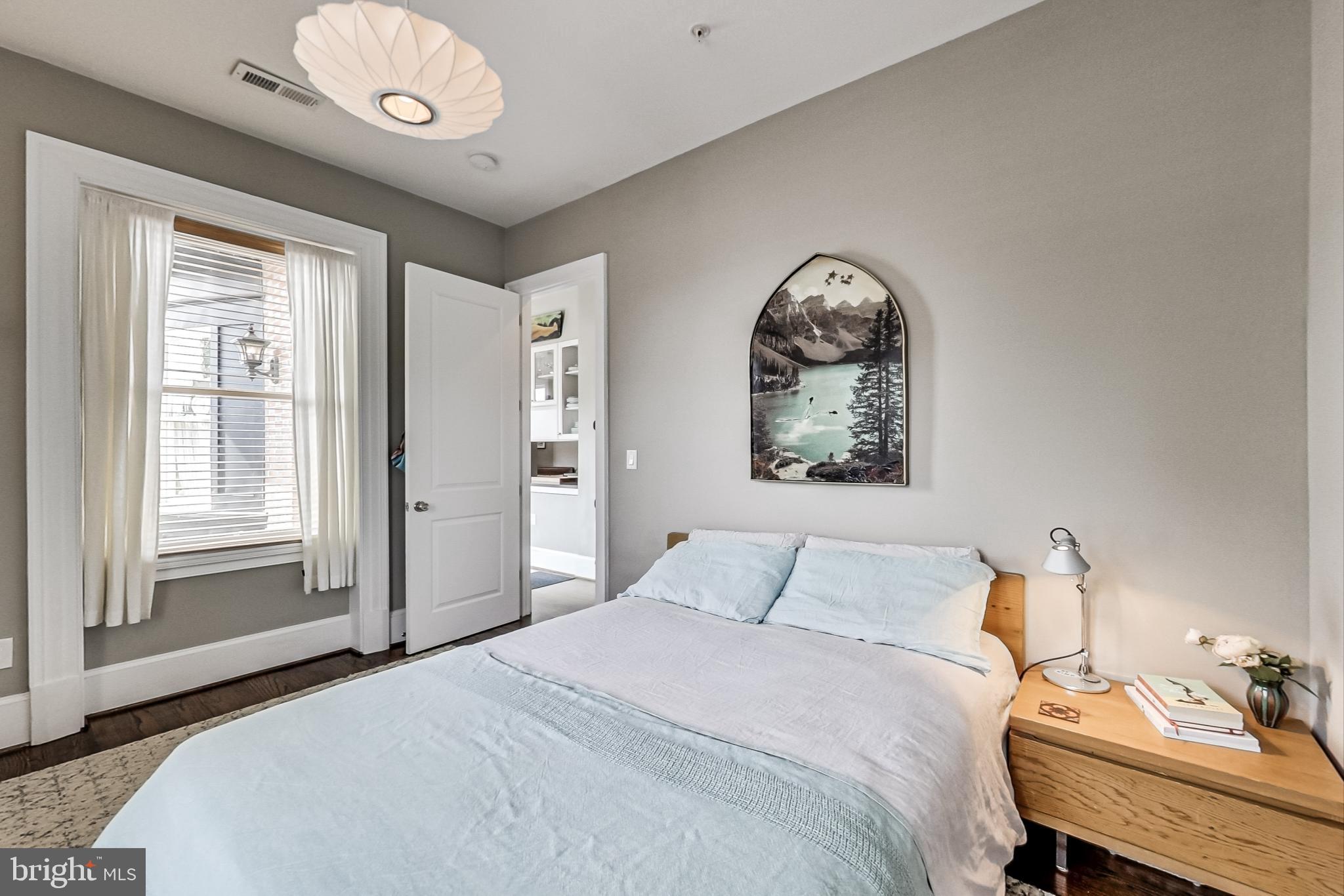 3324 18th Street Northwest, Unit 9 Washington, DC 20010 - Photo 27 of 44 a bedroom with a bed and a chandelier