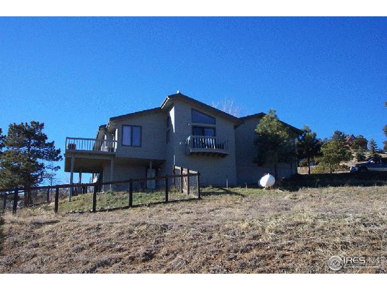 121 Chapman Road Boulder, CO 80302 - Photo 1 of 5 a view of a house with a backyard