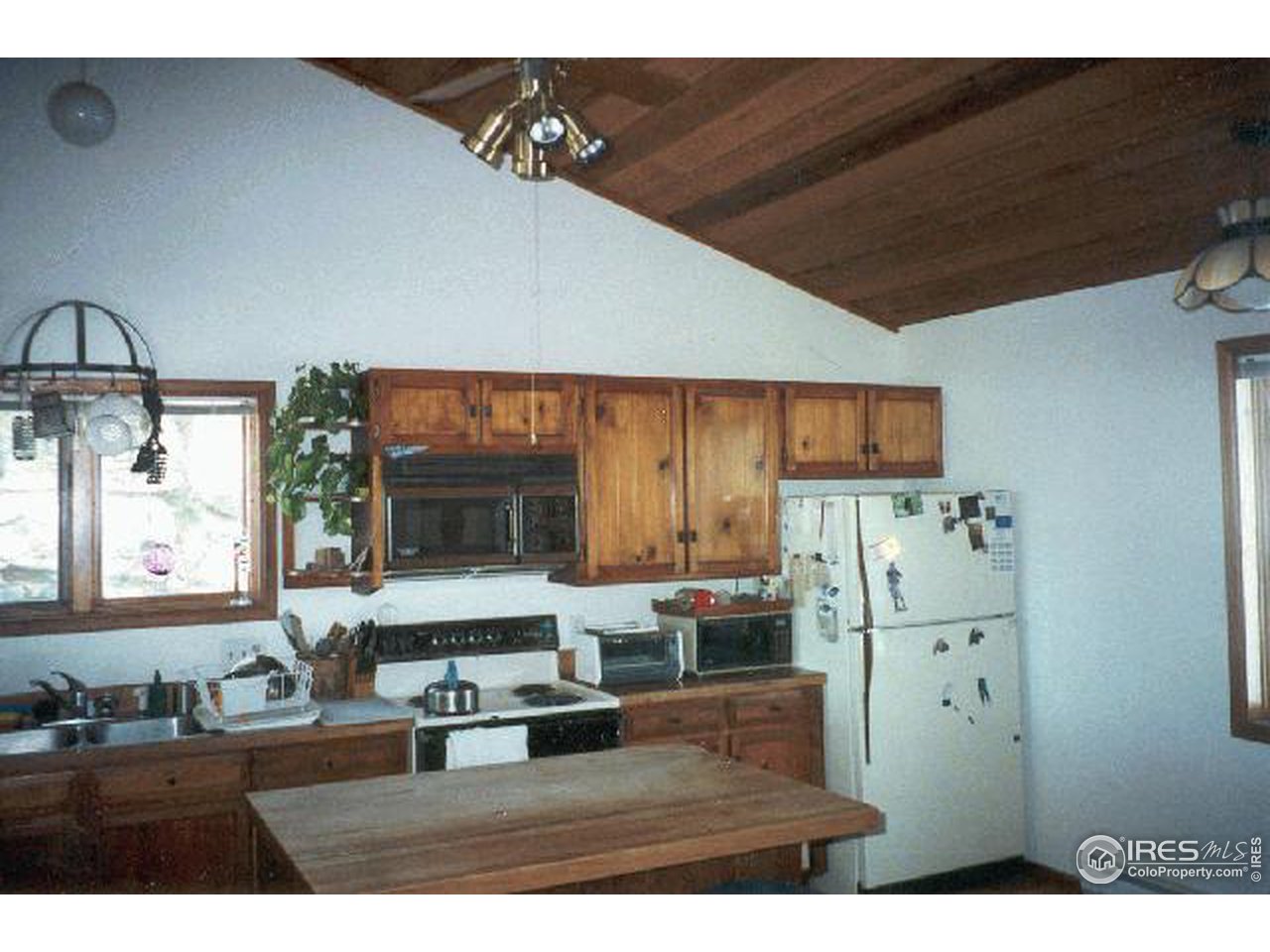 121 Chapman Road Boulder, CO 80302 - Photo 2 of 5 a kitchen with refrigerator and window