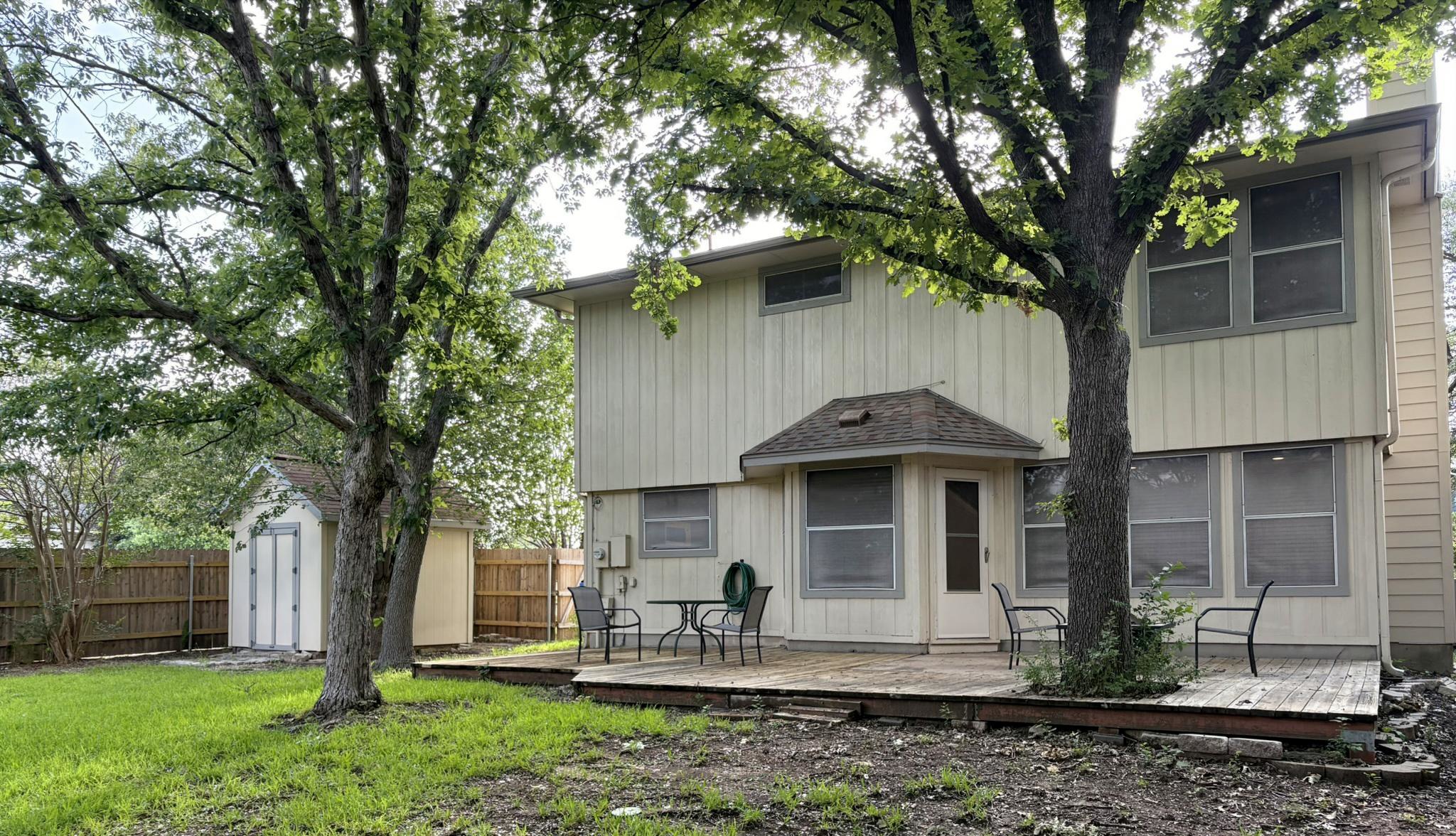 14707 Single Trace Austin, TX 78728 - Photo 4 of 17 A private backyard oasis features a wooden deck and ample green space for outdoor enjoyment.