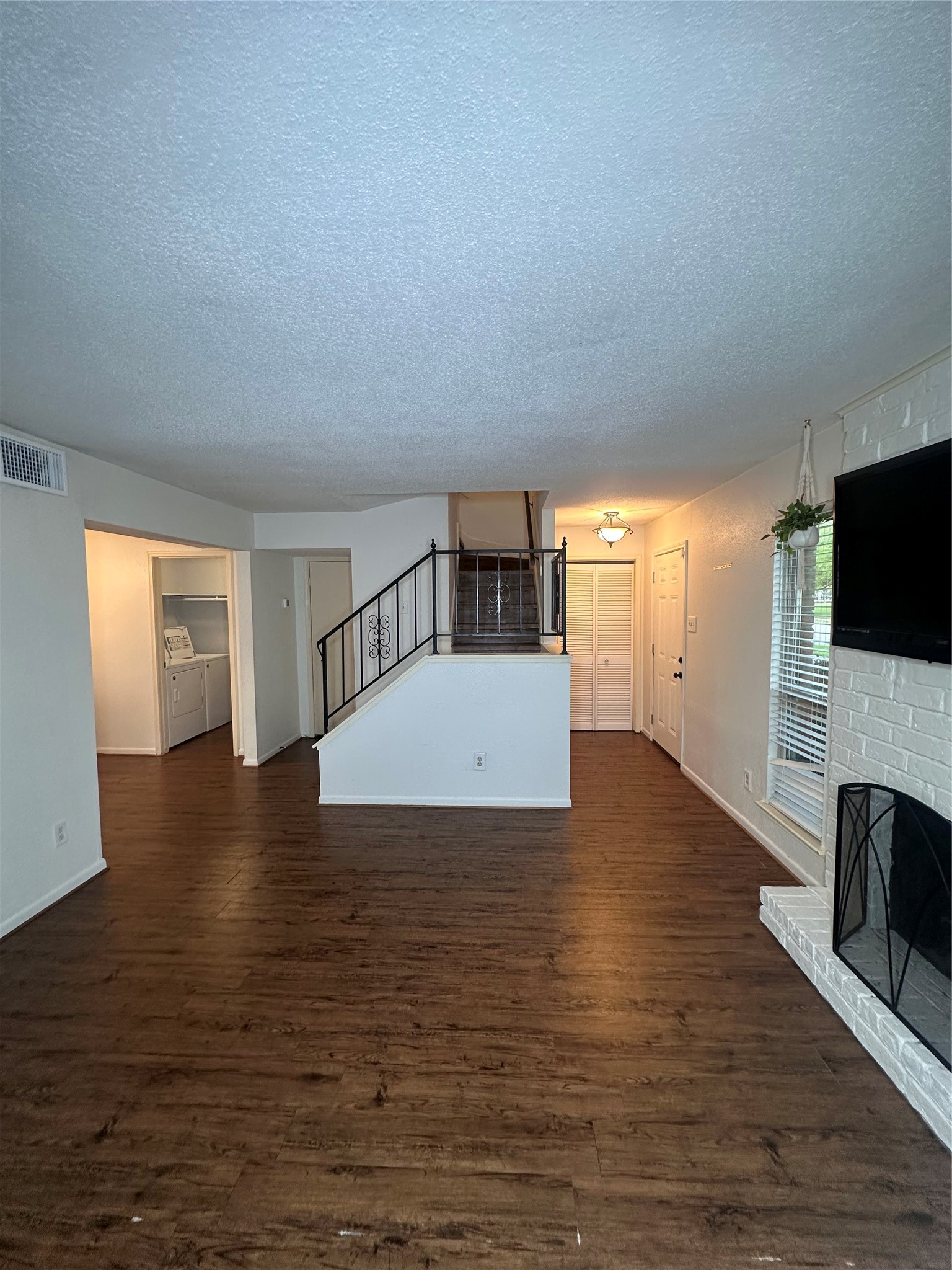 1413 Bonanza Road, Unit 413 Houston, TX 77062 - Photo 11 of 39 a view of a livingroom with wooden floor and a fireplace