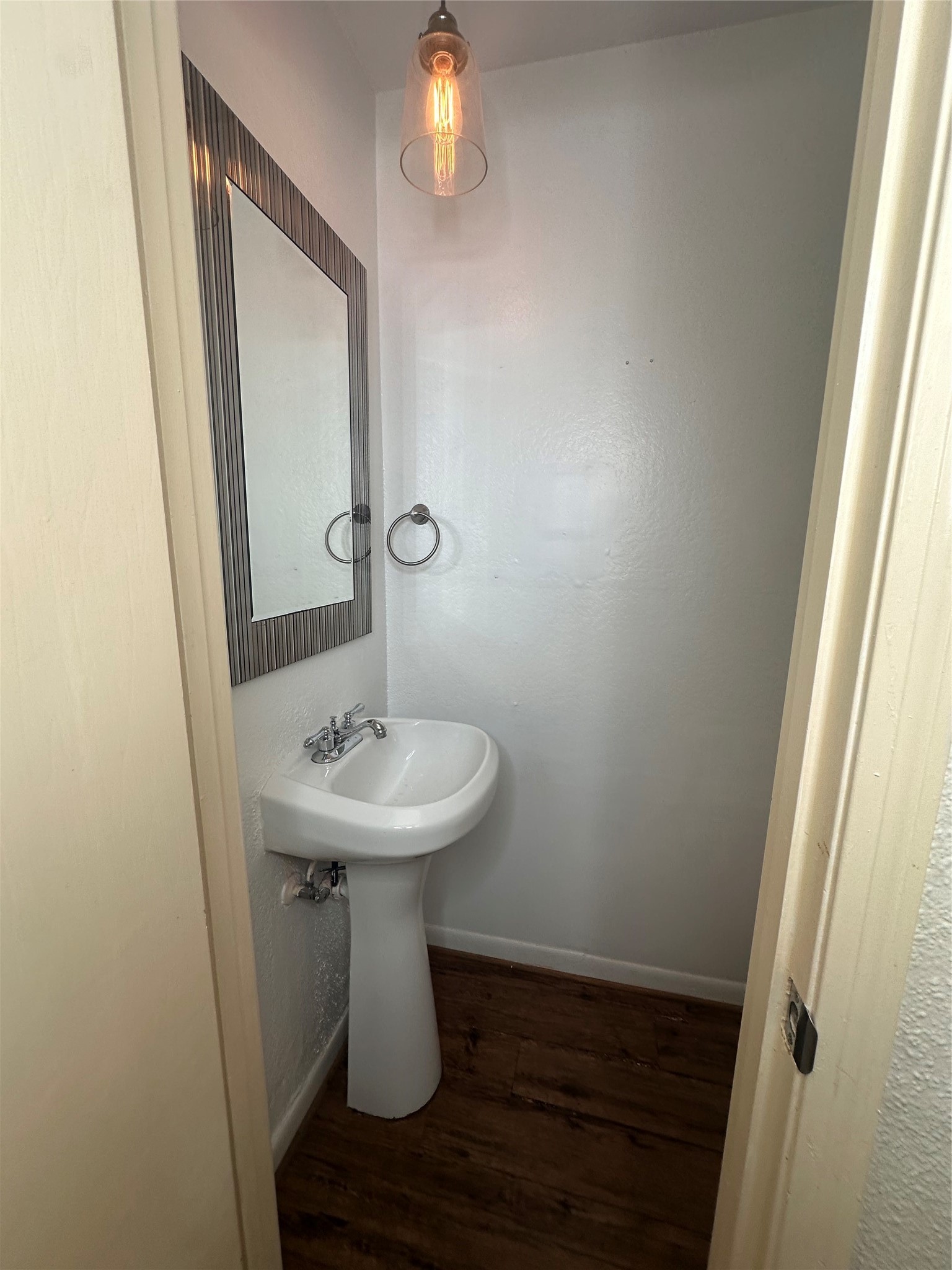 1413 Bonanza Road, Unit 413 Houston, TX 77062 - Photo 16 of 39 a bathroom with a sink a mirror and wooden floor