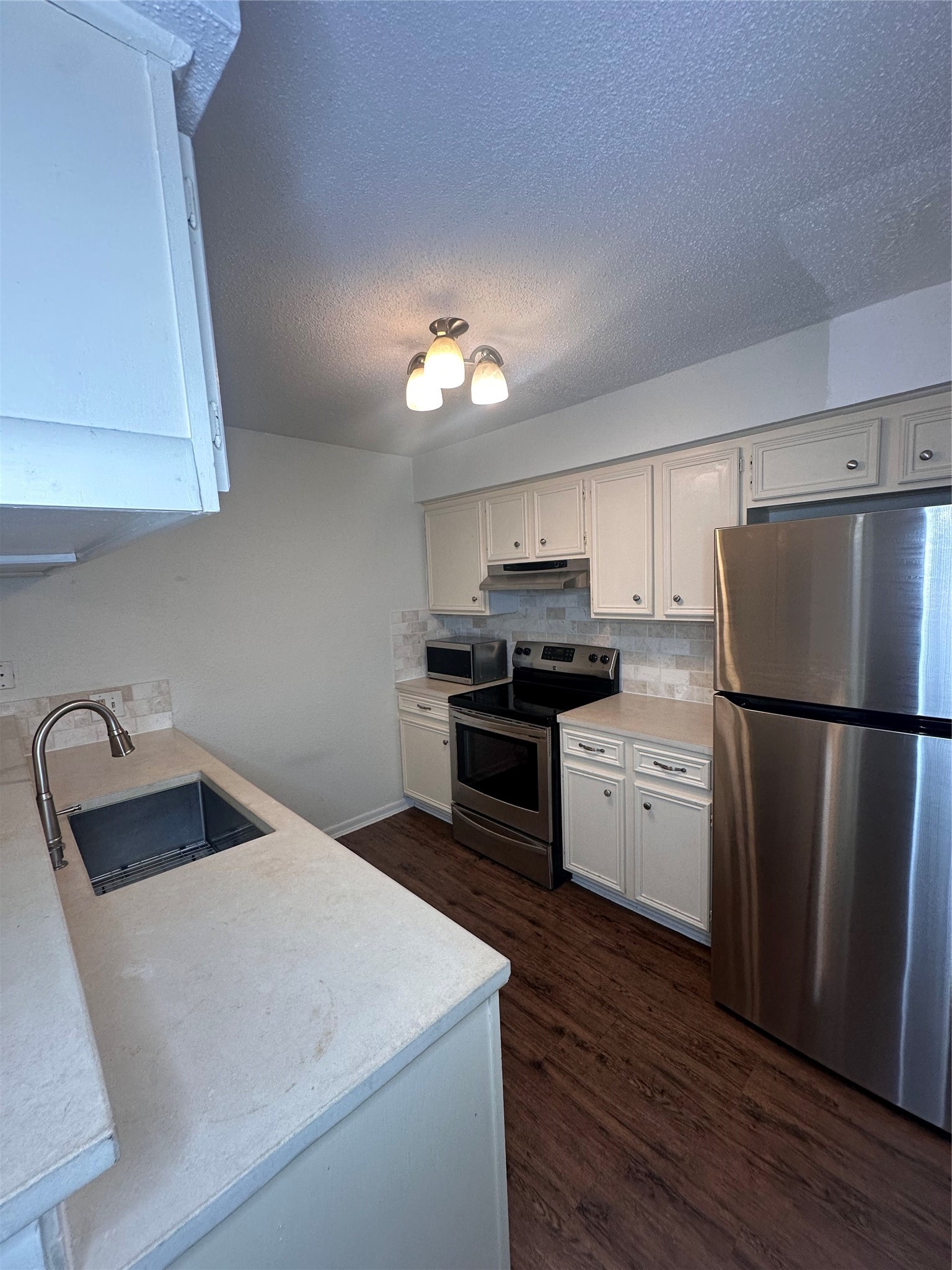 1413 Bonanza Road, Unit 413 Houston, TX 77062 - Photo 17 of 39 a kitchen with a refrigerator and a sink