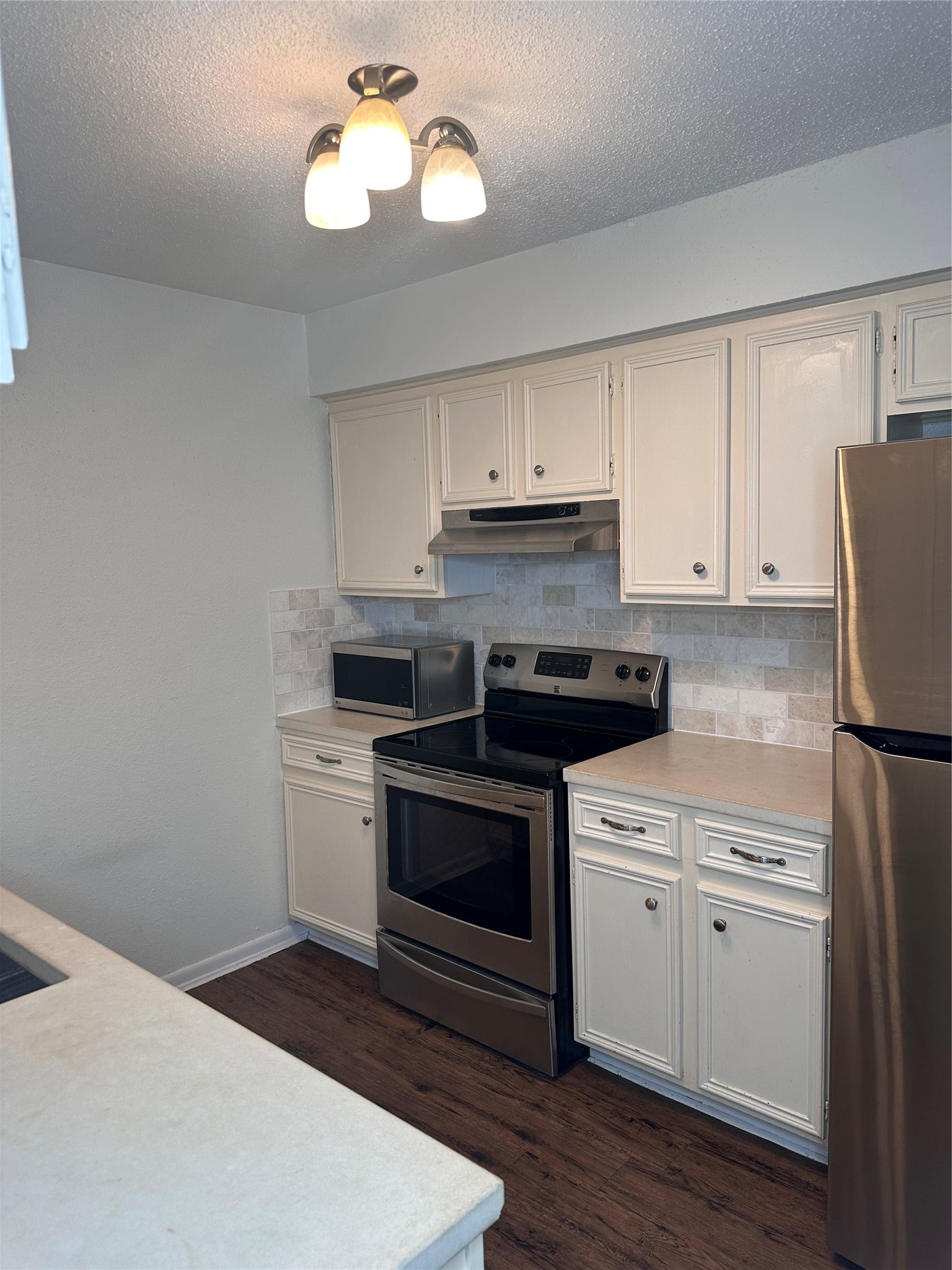 1413 Bonanza Road, Unit 413 Houston, TX 77062 - Photo 18 of 39 a kitchen with a stove cabinets and wooden floor