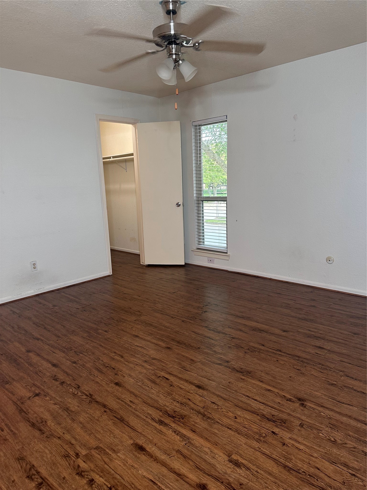 1413 Bonanza Road, Unit 413 Houston, TX 77062 - Photo 33 of 39 an empty room with wooden floor chandelier fan and windows
