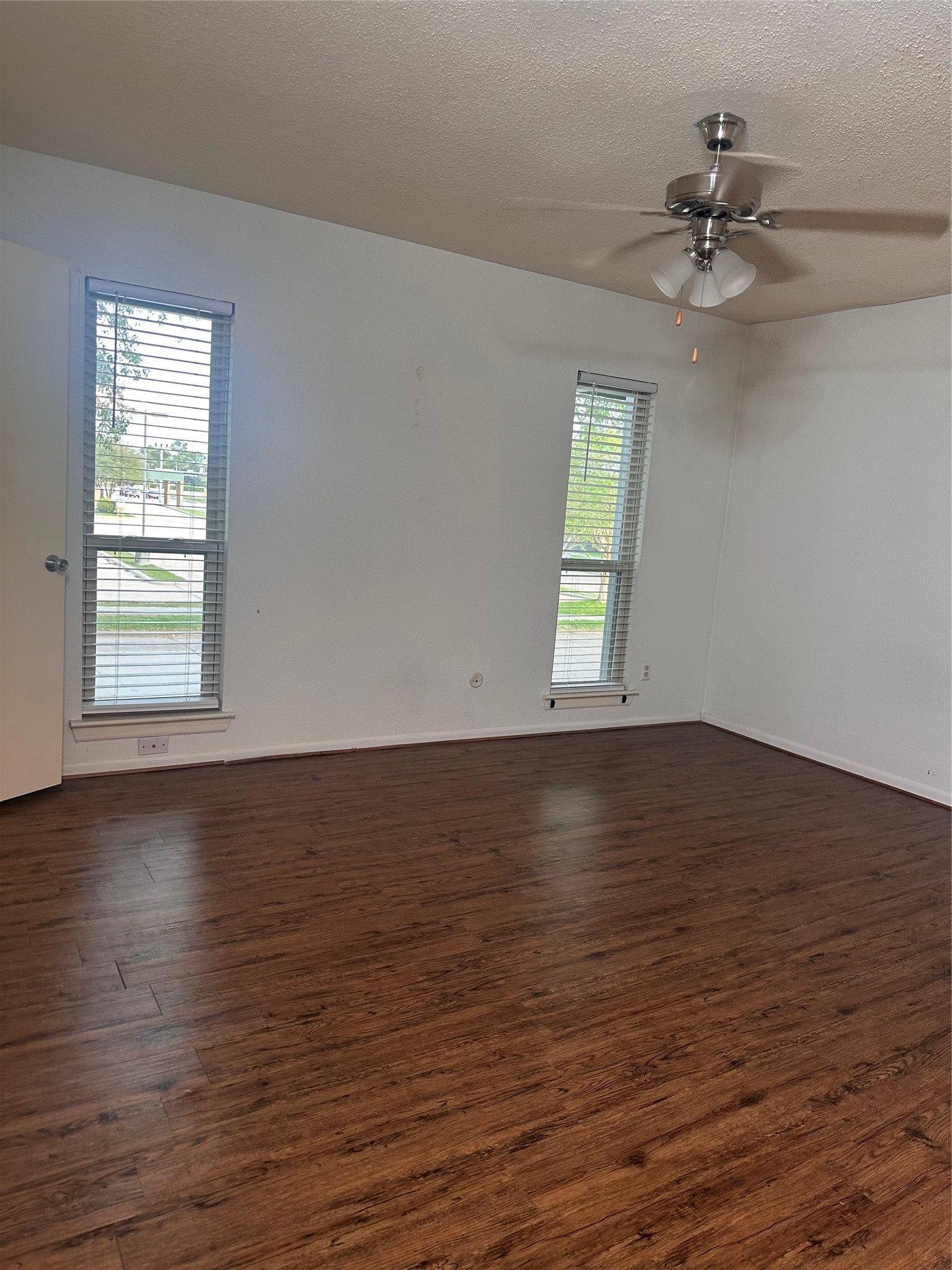 1413 Bonanza Road, Unit 413 Houston, TX 77062 - Photo 35 of 39 an empty room with wooden floor chandelier fan and windows
