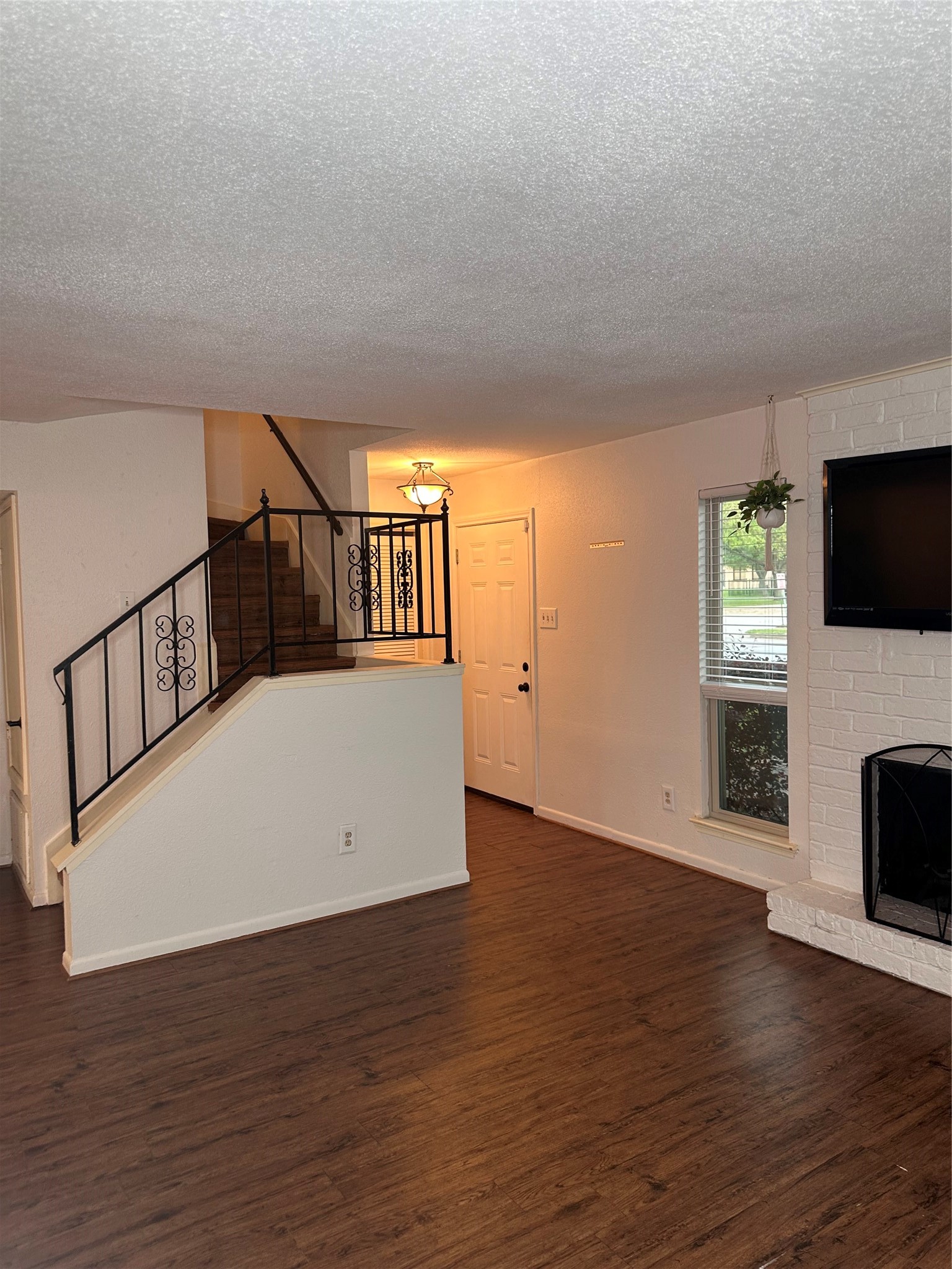1413 Bonanza Road, Unit 413 Houston, TX 77062 - Photo 7 of 39 a view of an empty room with wooden floor and a window