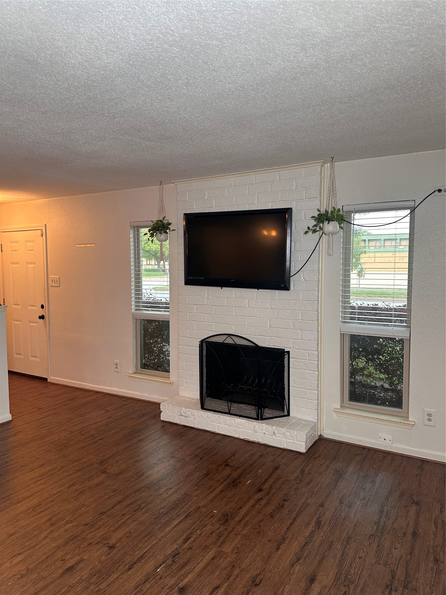 1413 Bonanza Road, Unit 413 Houston, TX 77062 - Photo 9 of 39 an empty room with windows fireplace and wooden floor