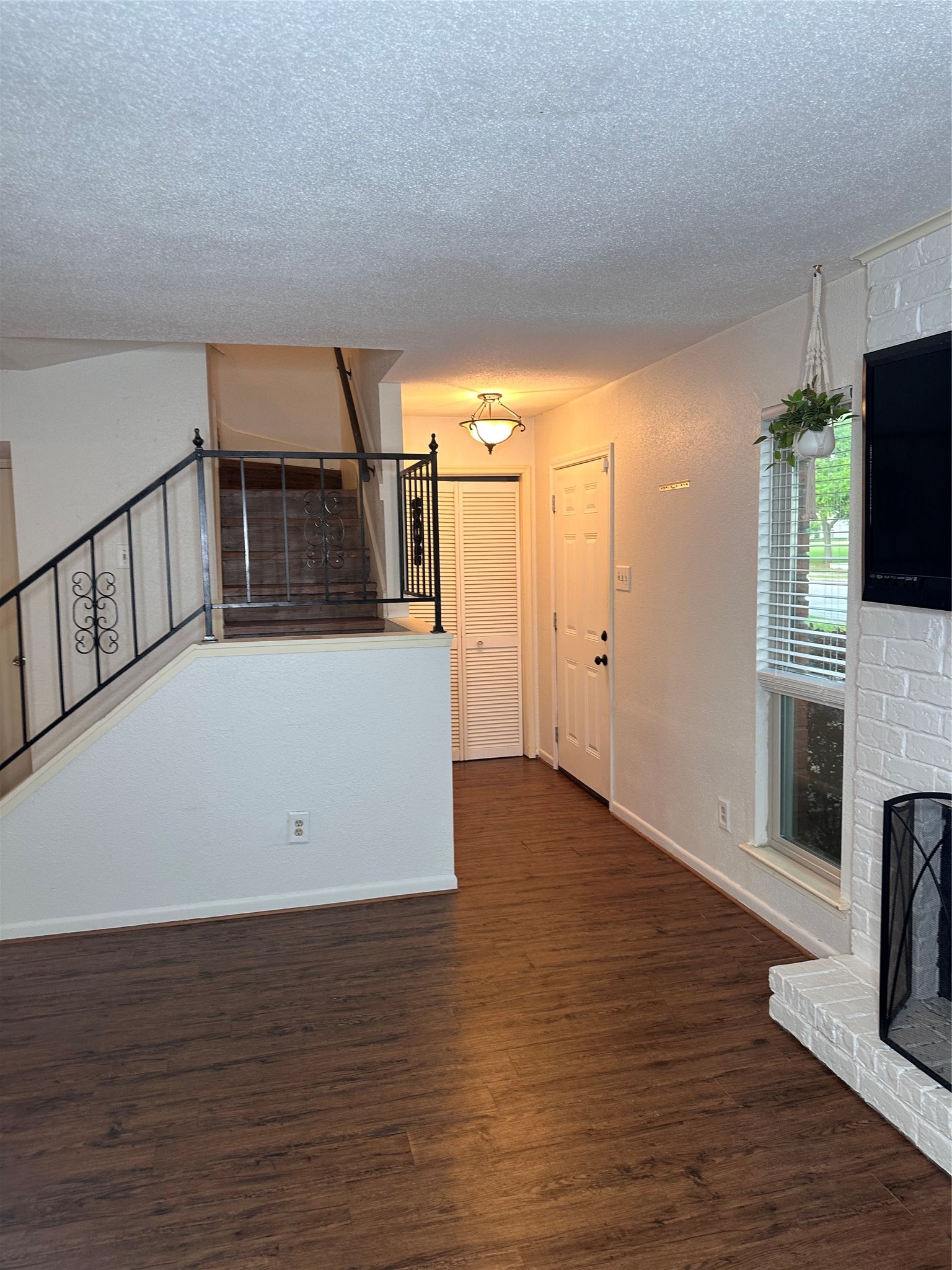 1413 Bonanza Road, Unit 413 Houston, TX 77062 - Photo 10 of 39 a view of a living room with hardwood floor and a fireplace