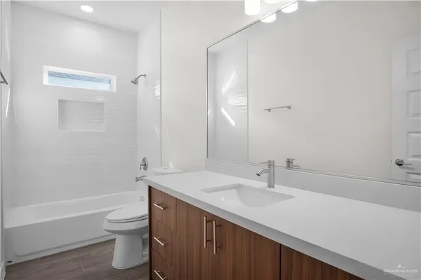 a bathroom with a sink a toilet and a bathtub
