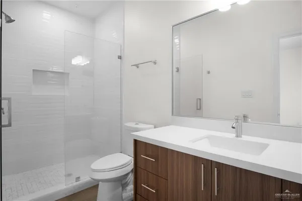 a bathroom with a sink toilet and shower