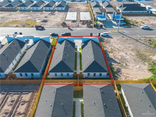 an aerial view of residential houses with outdoor space