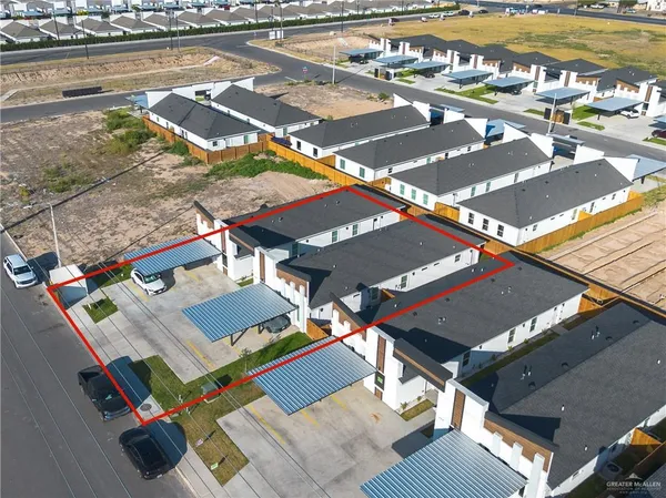 an aerial view of a swimming pool with outdoor seating