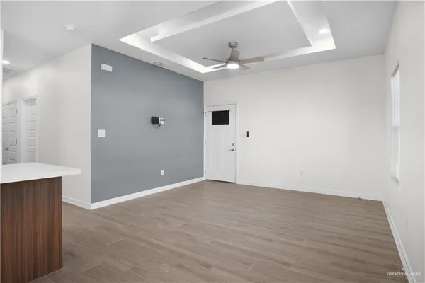 a view of an empty room with wooden floor