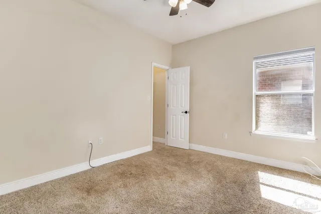 an empty room with windows and closet