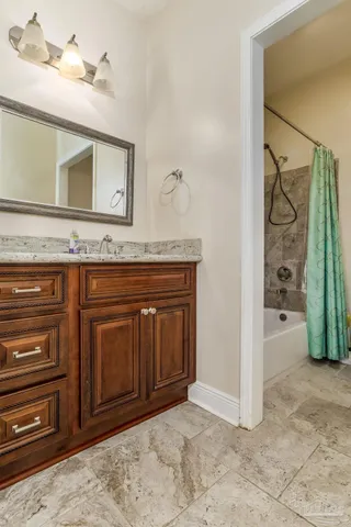 a view of a hallway with a cabinet and a mirror