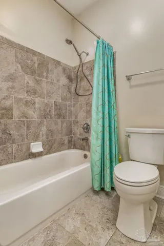 a bathroom with a toilet and a bathtub