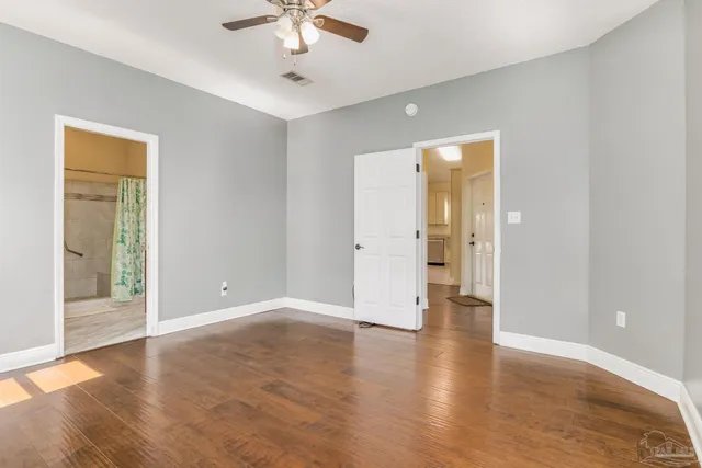 wooden floor in an empty room with a window