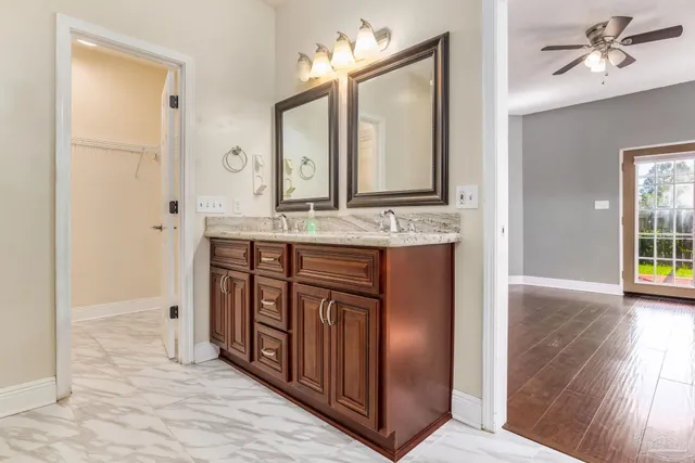 a bathroom with a granite countertop sink a mirror and a vanity