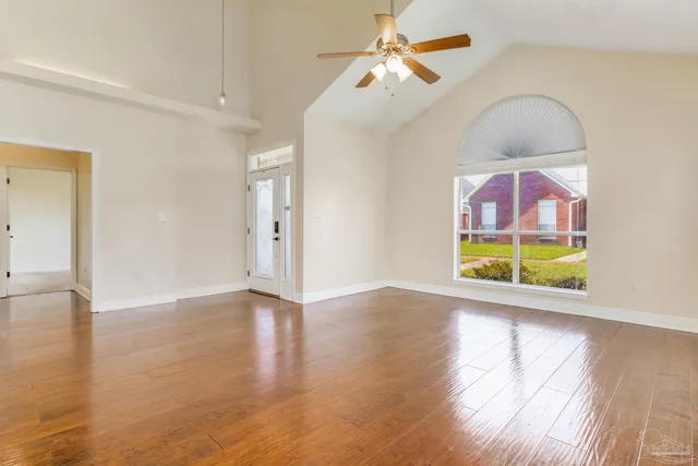 wooden floor in an empty room with a window