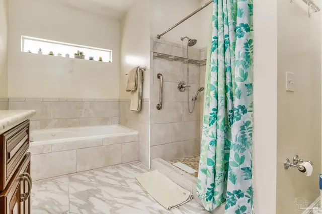 a bathroom with a bathtub and shower