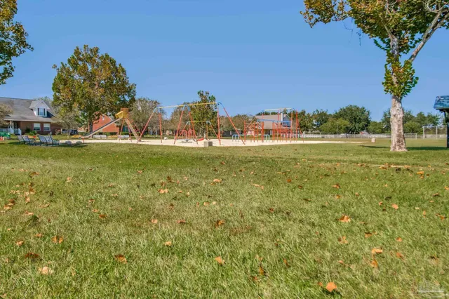 a view of a house with a yard and sitting area