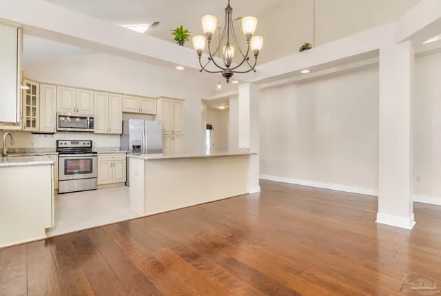 a view of a kitchen with microwave and stove top oven