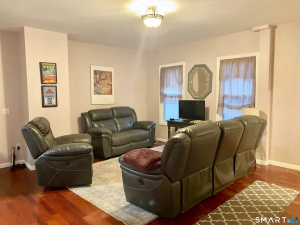 a living room with furniture a mirror and a window