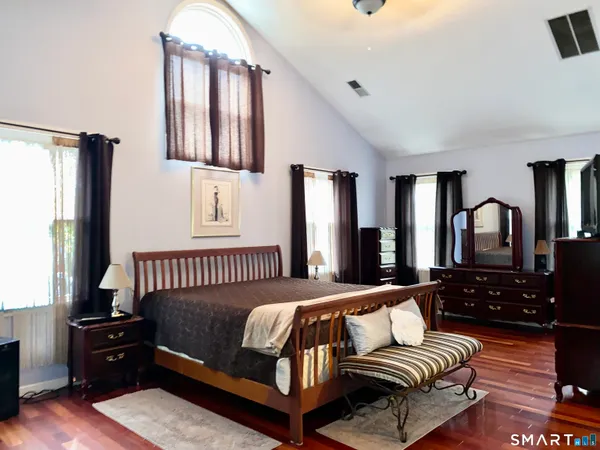 a bedroom with a bed couch and a window