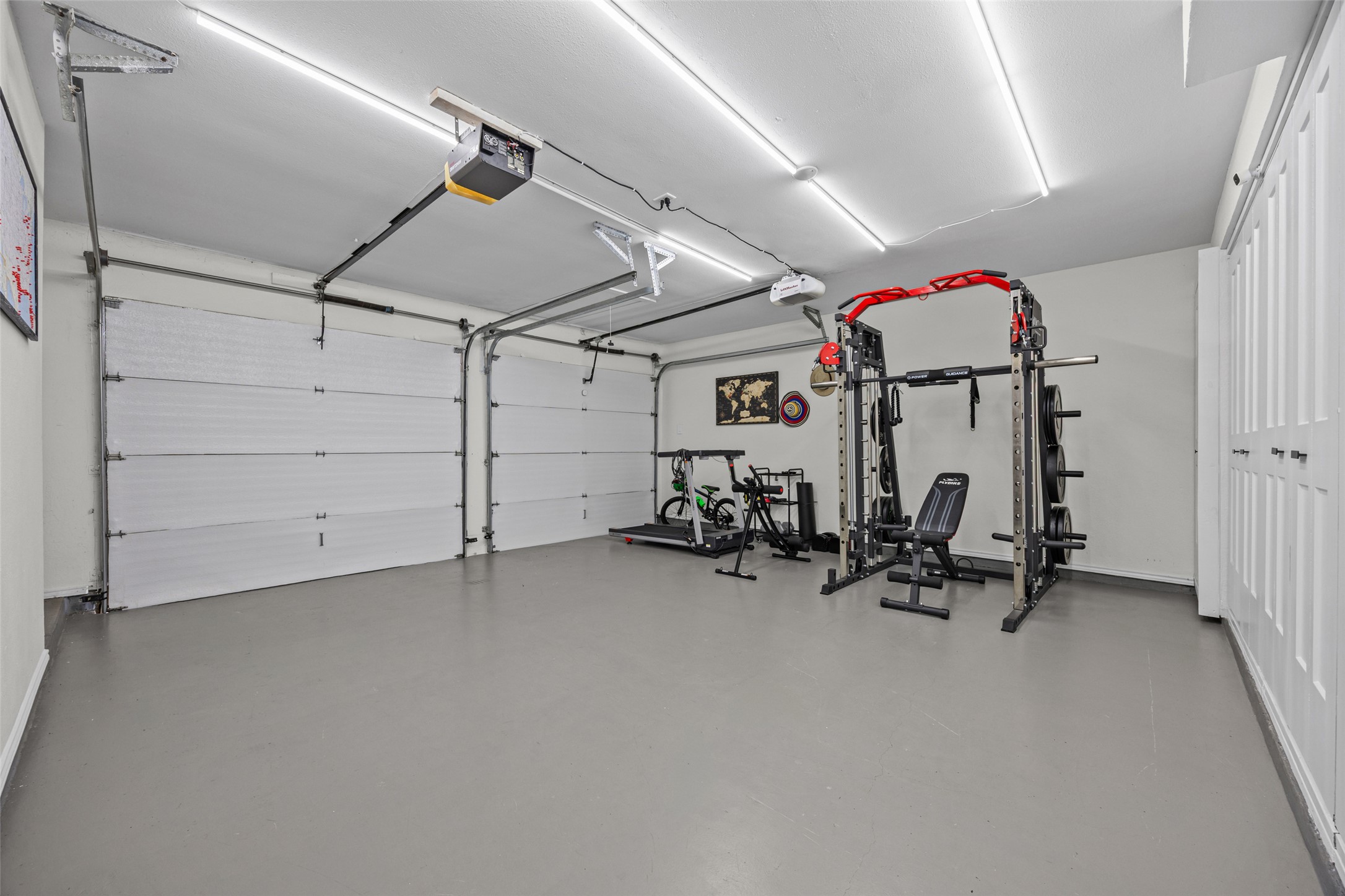 3006 Overland Street Round Rock, TX 78681 - Photo 25 of 29 Bright fluorescent lighting illuminates this clean garage space complete with painted concrete flooring.