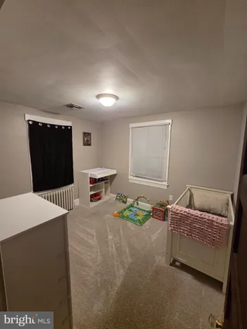 a bedroom with a bed and a tv