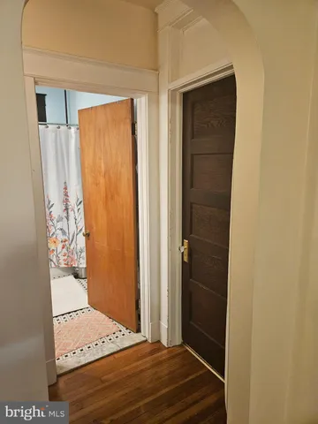 a view of a kitchen with kitchen island a counter top space cabinets and stainless steel appliances