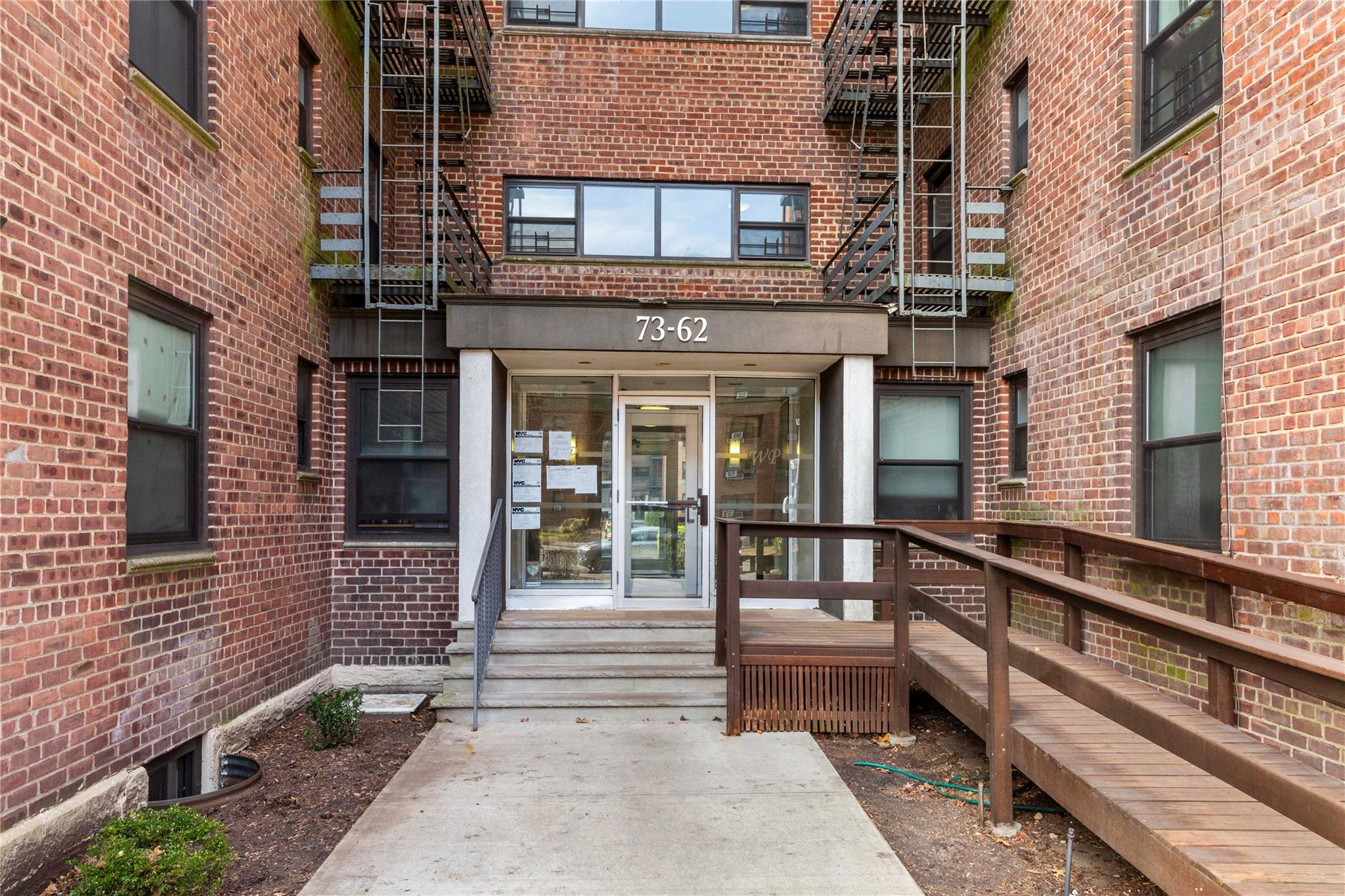 View of exterior entry with brick siding
