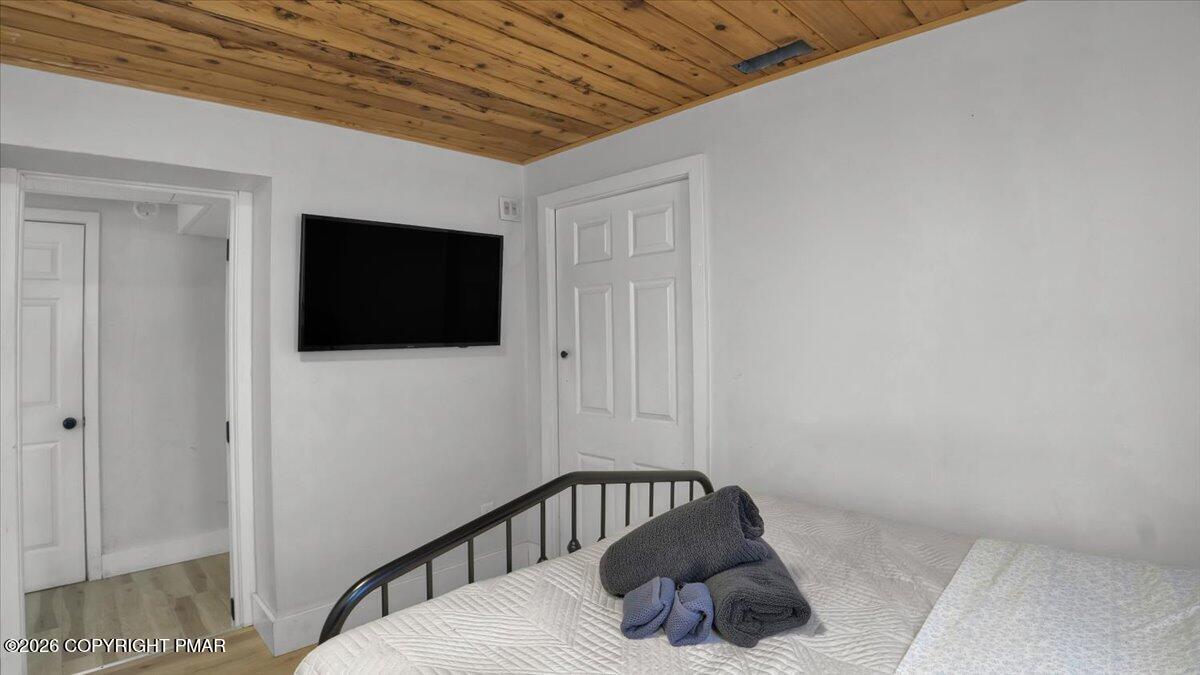 65 Highridge Road Albrightsville, PA 18210 - Photo 16 of 60 a bedroom with a bed and a flat screen tv