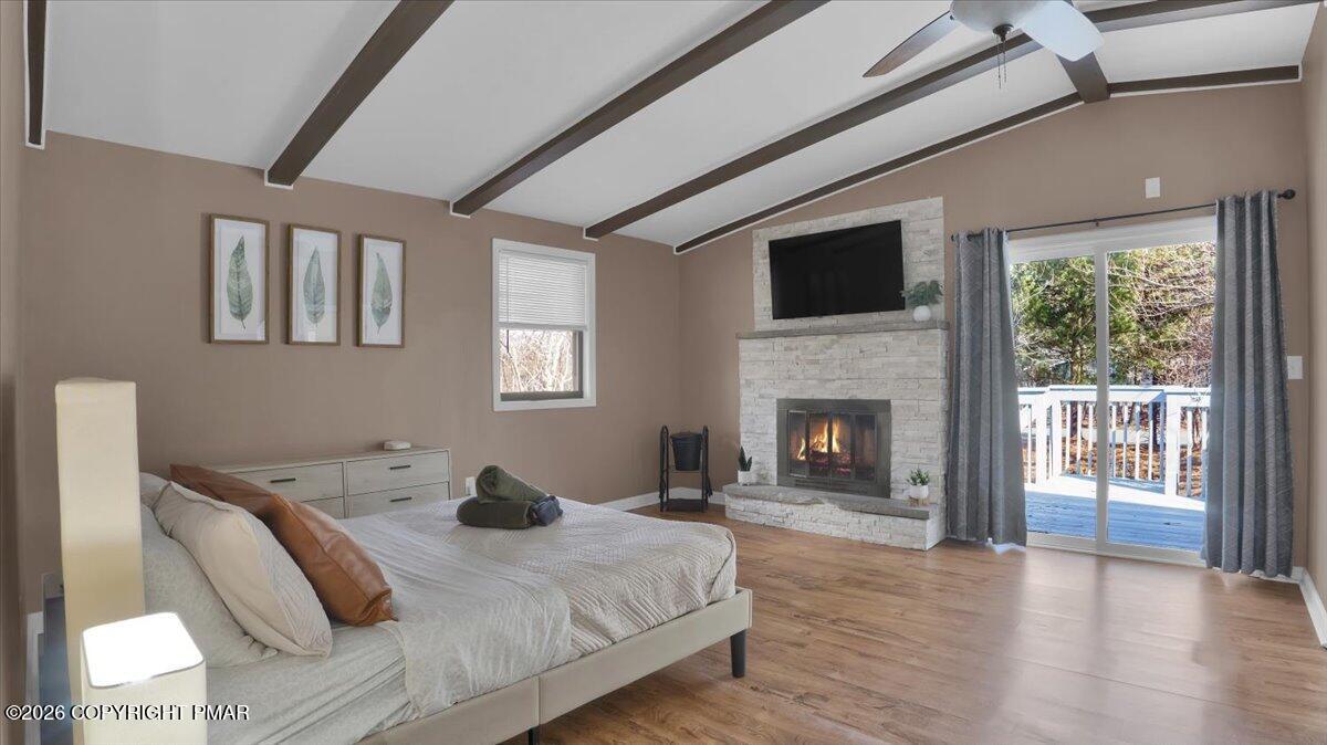 65 Highridge Road Albrightsville, PA 18210 - Photo 2 of 60 a bedroom with a bed and a fireplace