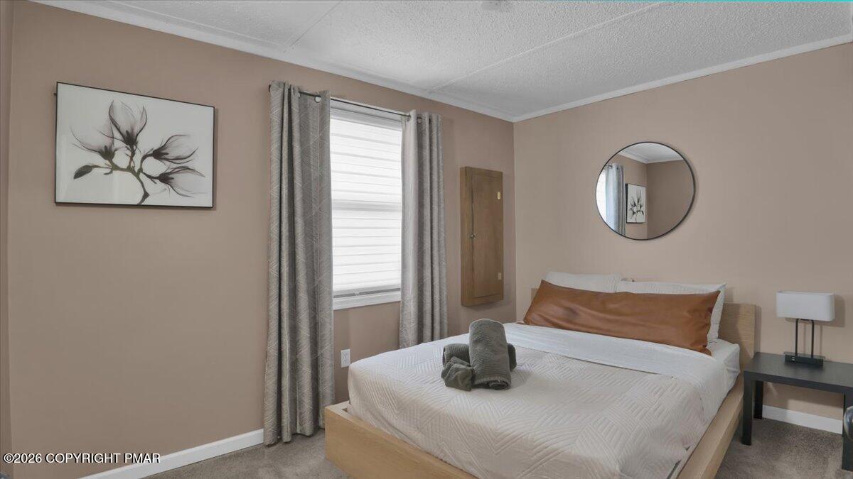 65 Highridge Road Albrightsville, PA 18210 - Photo 23 of 60 a bedroom with a bed and a painting on the wall