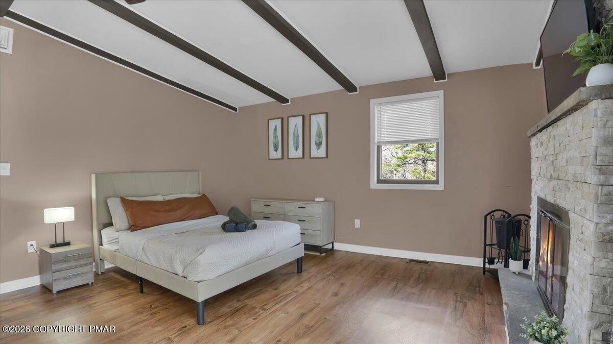 65 Highridge Road Albrightsville, PA 18210 - Photo 25 of 60 a bedroom with a bed and wooden floor