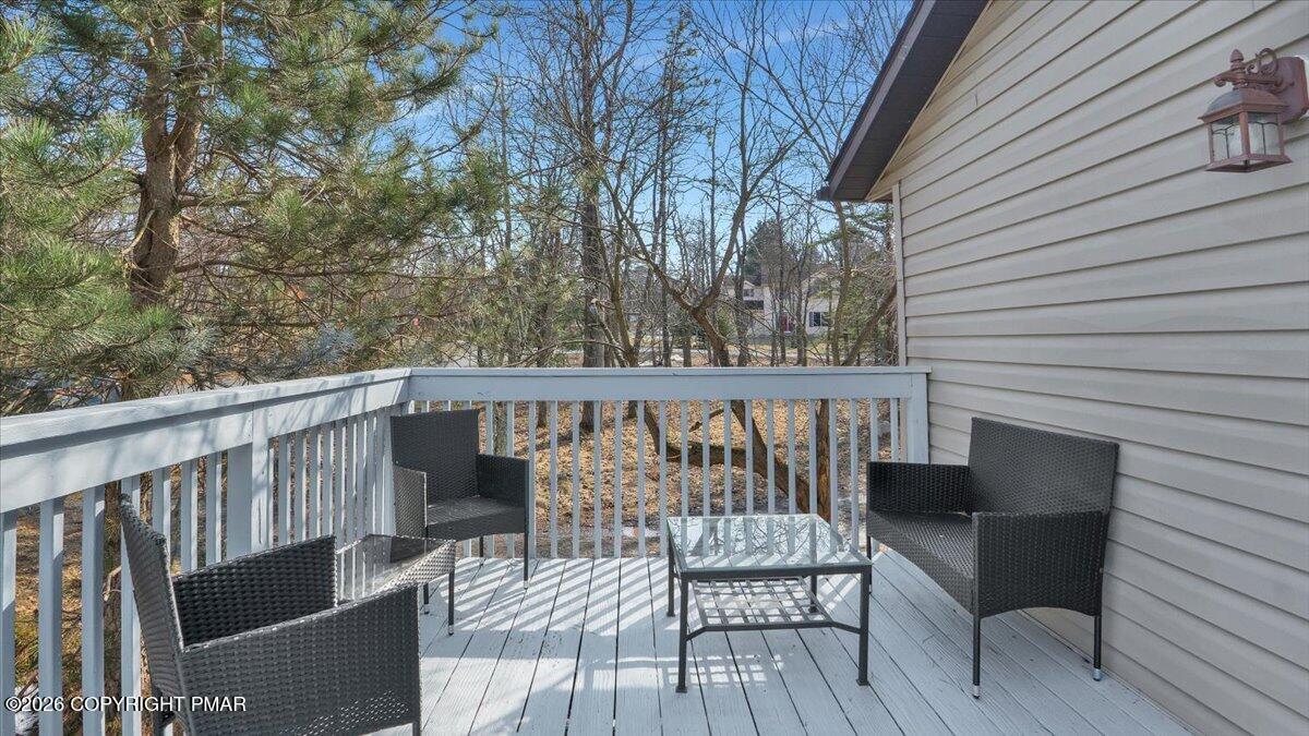65 Highridge Road Albrightsville, PA 18210 - Photo 29 of 60 a balcony with wooden floor table and chairs