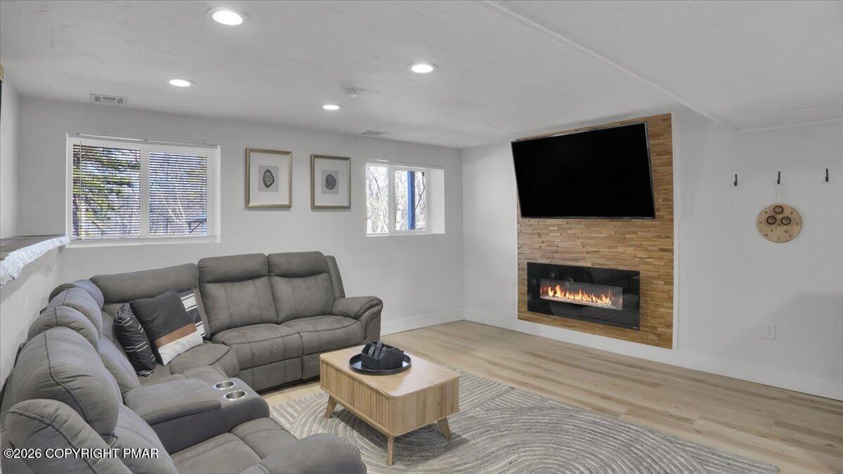 65 Highridge Road Albrightsville, PA 18210 - Photo 4 of 60 a living room with furniture a fireplace and a flat screen tv