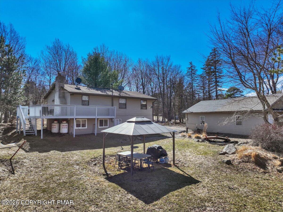 65 Highridge Road Albrightsville, PA 18210 - Photo 46 of 60 a patio with a table and chairs under an umbrella