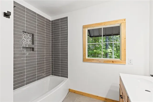 a bathroom with a sink a mirror and a window